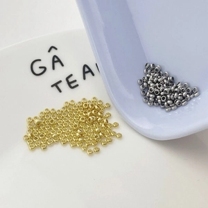 2mm gold and silver spacer beads for DIY jewelry making shown in macro view