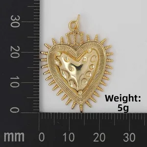Detailed view of a golden heart crown pendant with sunburst rays on a measuring scale