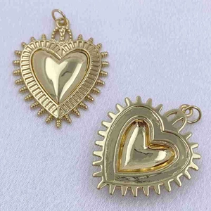Detailed front and back view of gold heart pendants with unique sunburst texture edges