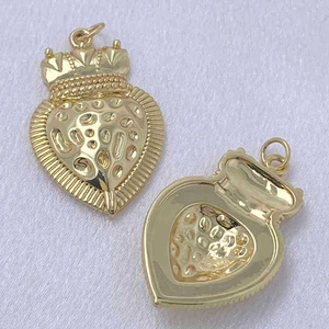 Detailed view of gold crown heart pendants showing front texture and hollow back design