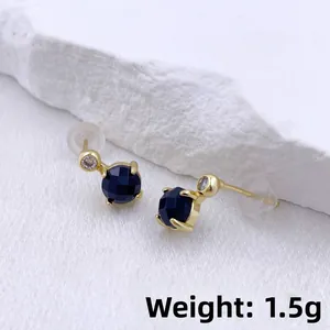 Detailed macro view of heart-shaped blue zircon earrings with gold finish, weight 1.5g