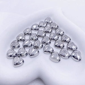 Close-up of heart-shaped letter charms with crystals for DIY jewelry bracelets