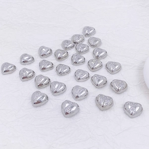 Detailed view of silver heart-shaped pendants with zircon alphabet letters A-Z