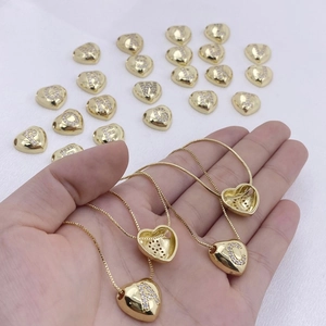 Close-up of gold heart initial necklaces featuring sparkling A-Z crystal engravings
