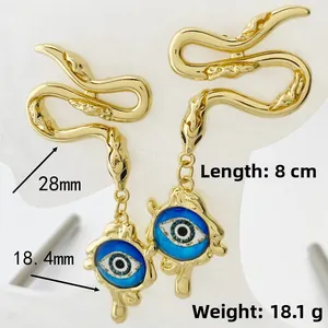 Close-up of gold snake earrings with blue evil eye pendant, length 8cm and weight 18.1g