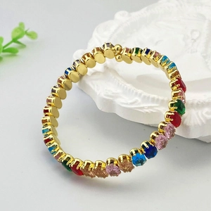 Détail d'un bracelet doré ajustable orné de zircons multicolores à coupe ronde