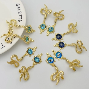 Detailed close-up of snake earrings with colorful evil eye charms in gold finish
