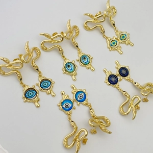 Gold snake stud earrings with devil's eye nazar charms in various blue shades