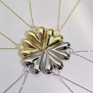Top view of eight 3D heart pendants in gold and silver finish with mirror polishing