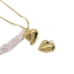 Polished 18K gold heart pendant necklace with elegant box chain on white background
