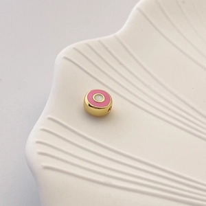 Detail einer pinkfarbenen Emaille-Abstandshülse mit Goldrand für die DIY-Schmuckherstellung