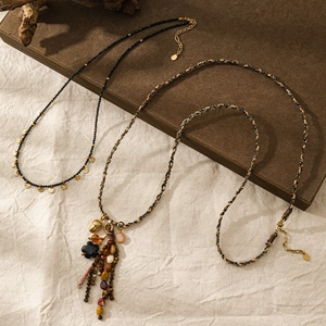 Collana lunga vintage in corda intrecciata con nappe floreali in pietra naturale e bronzo