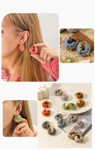 Close-up of handmade colorful crochet yarn wrapped hoop earrings with textured wool finish