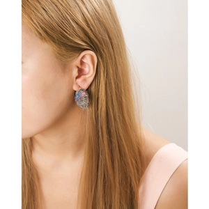 Close-up of handmade textured wool oval earrings in vibrant colors worn by a model