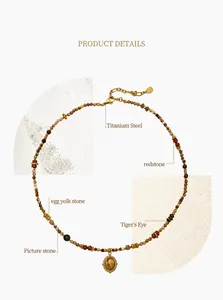 Detail of natural stone beads with tiger eye and red stone on vintage titanium necklace