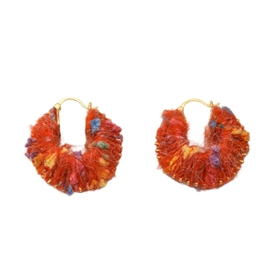 Colorful handmade yarn hoop earrings with orange knit texture and vibrant bohemian style accents