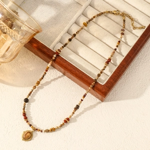 Bohemian natural stone beaded necklace with oval pendant and adjustable gold clasp