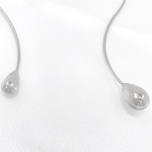 Detailed view of silver-tone polished metal choker with minimalist teardrop pendants