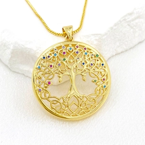 Elegant gold tree of life pendant necklace with colorful cubic zirconia on white silk cloth