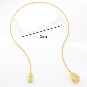 Detail view of 13mm gold water drop pendants on a minimalist punk style choker necklace