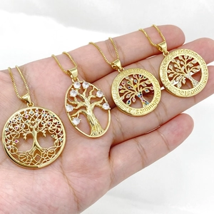 Macro detail of hand-held gold tree of life pendants with micro-paved zircons