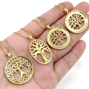 Macro view of four tree of life pendants in gold finish with micro-inlaid zircons