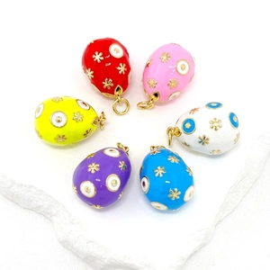 Set of 6 colorful enamel Easter egg pendants with gold snowflake patterns on white stone