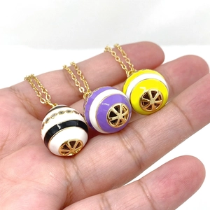 Close-up of colorful enamel Easter egg pendants with zircons on a gold-plated chain