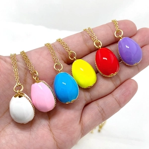 Detail of colorful Easter egg pendants with enamel finish and white zircon stones