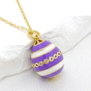 Close-up of 14K gold Easter egg pendant with purple enamel stripes and zircon accents