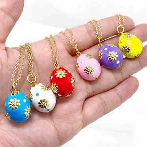 Detailed view of six colorful enamel Easter egg pendants with gold floral accents