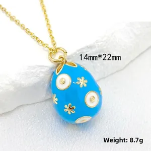 Detailed view of royal blue enamel egg pendant with 14K gold accents and 14mmx22mm size