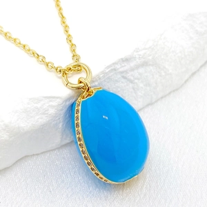 Elegant 14K gold-plated Easter egg pendant necklace with blue enamel and sparkling zircons