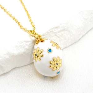 14K gold plated Easter egg pendant necklace featuring white enamel and floral patterns