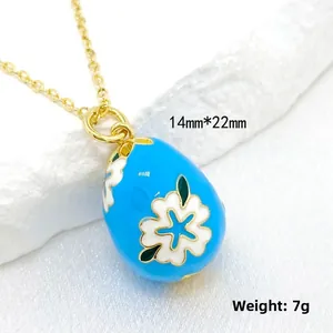 Detail view of Faberge style 14K gold egg pendant with 14mm by 22mm size and 7g weight