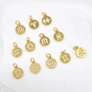 Set of twelve hollow golden zodiac charms for DIY jewelry making displayed on white background