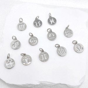 Close-up of silver hollow round zodiac pendants for DIY necklace and jewelry making
