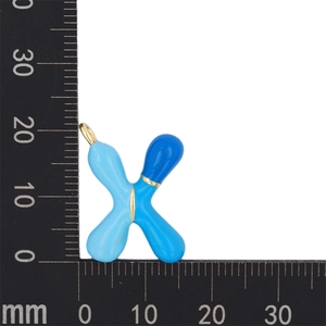 Macro detail of blue gradient enamel letter X pendant measured with a metric ruler
