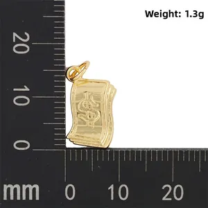 Makroaufnahme eines 11mm Mini-Dollar-Anhängers in Gold auf einem schwarzen Maßstab