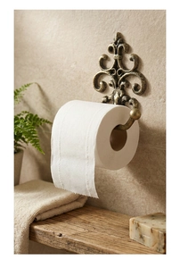 Detail of vintage cast iron towel holder with European retro patterns on a stone wall