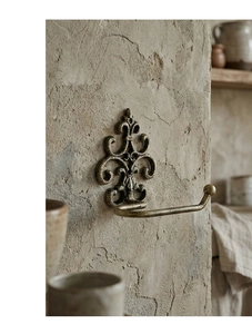 Detail of vintage cast iron towel holder with European scrollwork and iris elements