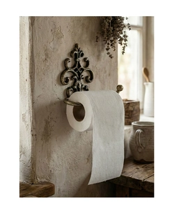 Detail of vintage fleur-de-lis cast iron paper towel holder with antique bronze finish