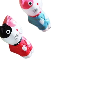 Set of two handcrafted wooden cat figurines with colorful striped shirts in Nordic style