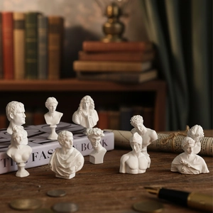 Classic set of mini white resin plaster sculptures on a vintage wooden desk
