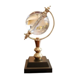 Modern crystal globe ornament with gold metal stand and black base for home desk decor