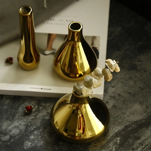 Minimalist gold ceramic vase set on marble surface for modern luxury home decor