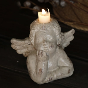 Vintage Nordic cupid angel candle holder with antique resin finish and glowing candle