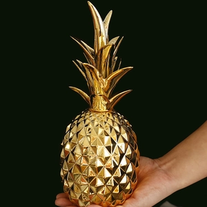 Golden ceramic pineapple decor with geometric facets, modern luxury home ornament