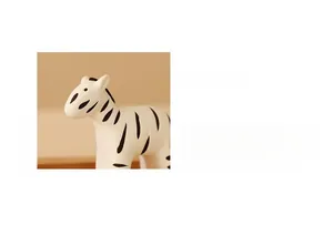 Close-up of zebra ceramic figurine showing hand-painted patterns and minimalist design