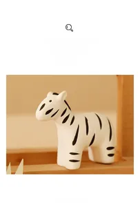 Detailed view of hand-painted zebra ceramic ornament with matte finish and minimalist design